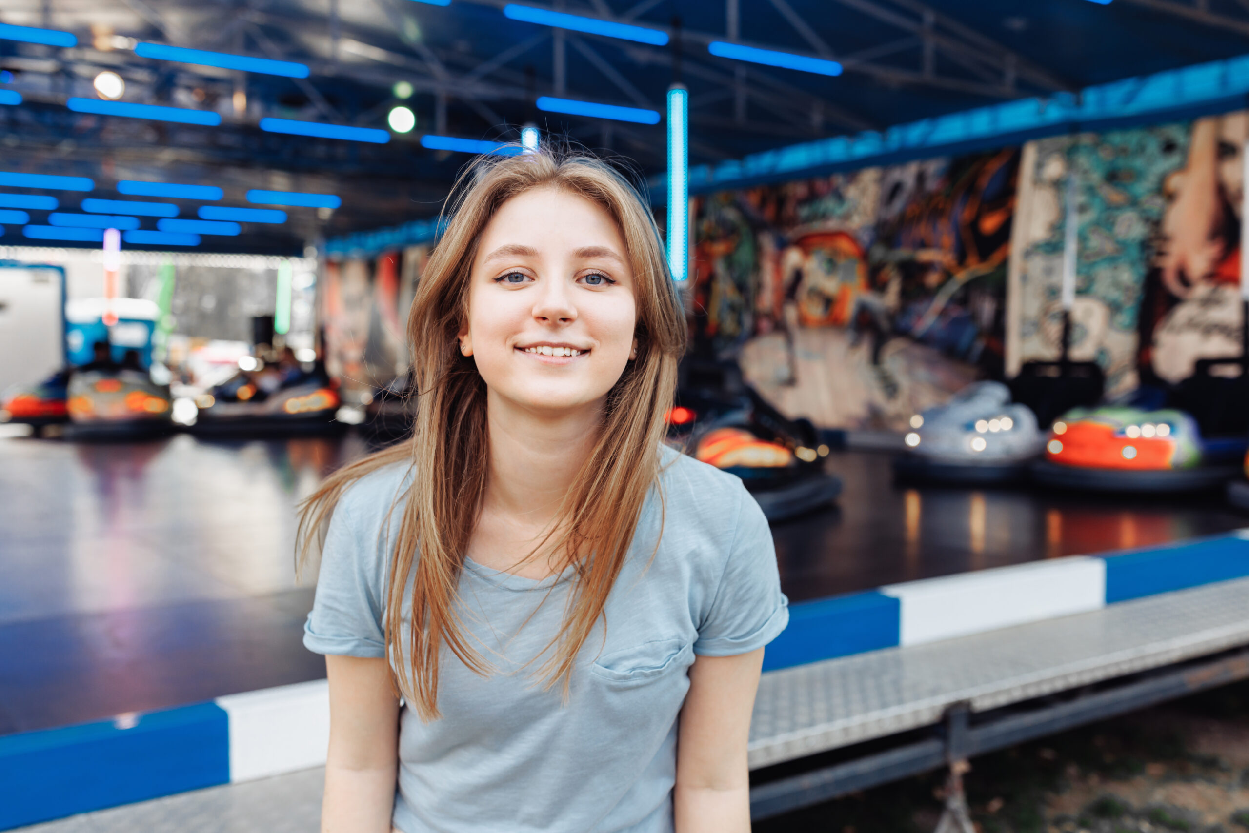 person sitting in front of bumper cars at an amusement park