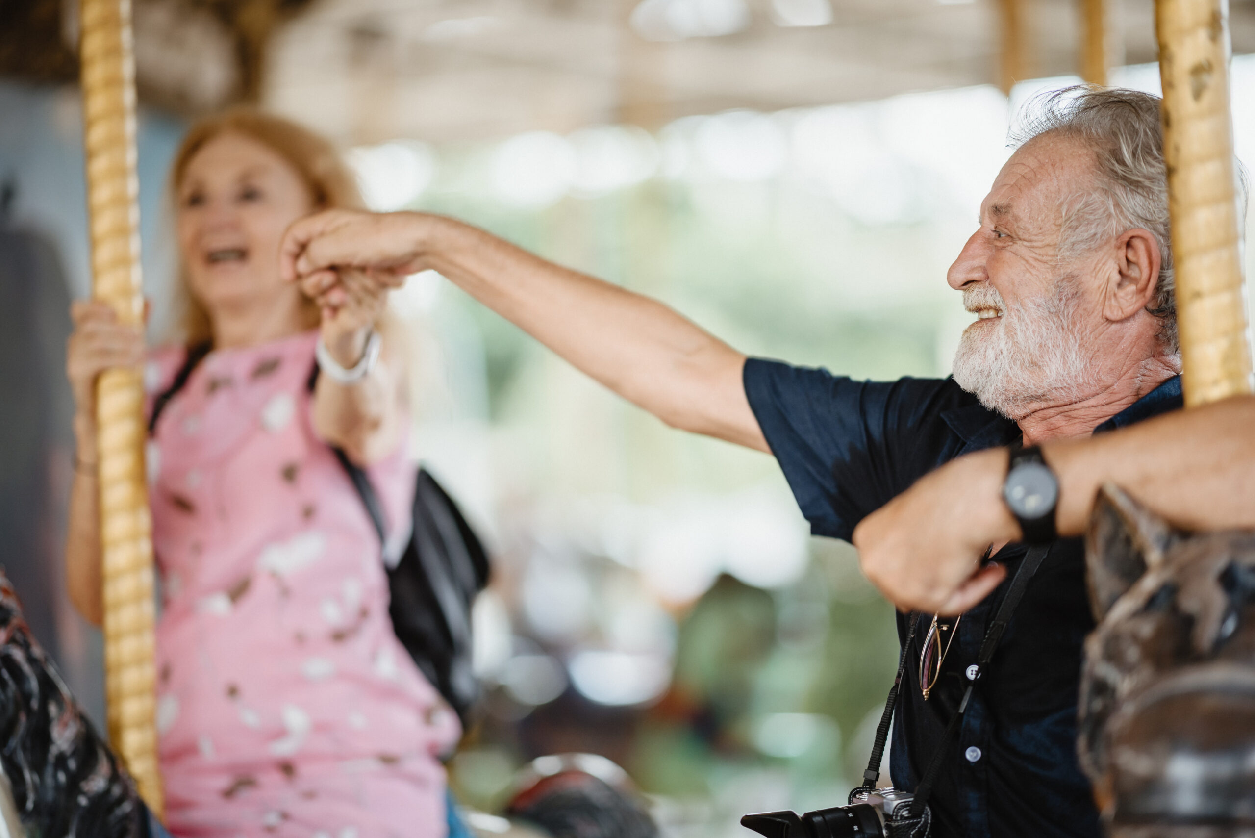 two people on a carousel at a theme park