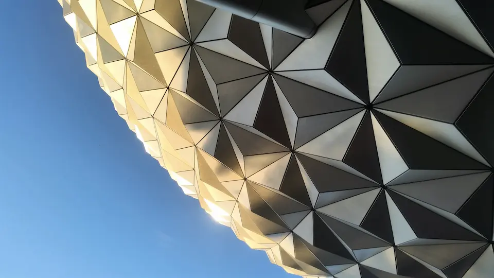 Spaceship Earth’s geometric exterior against a blue sky at EPCOT