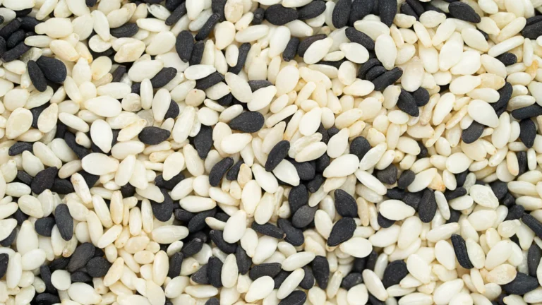 A close view of black and pale sesame seeds mixed together.