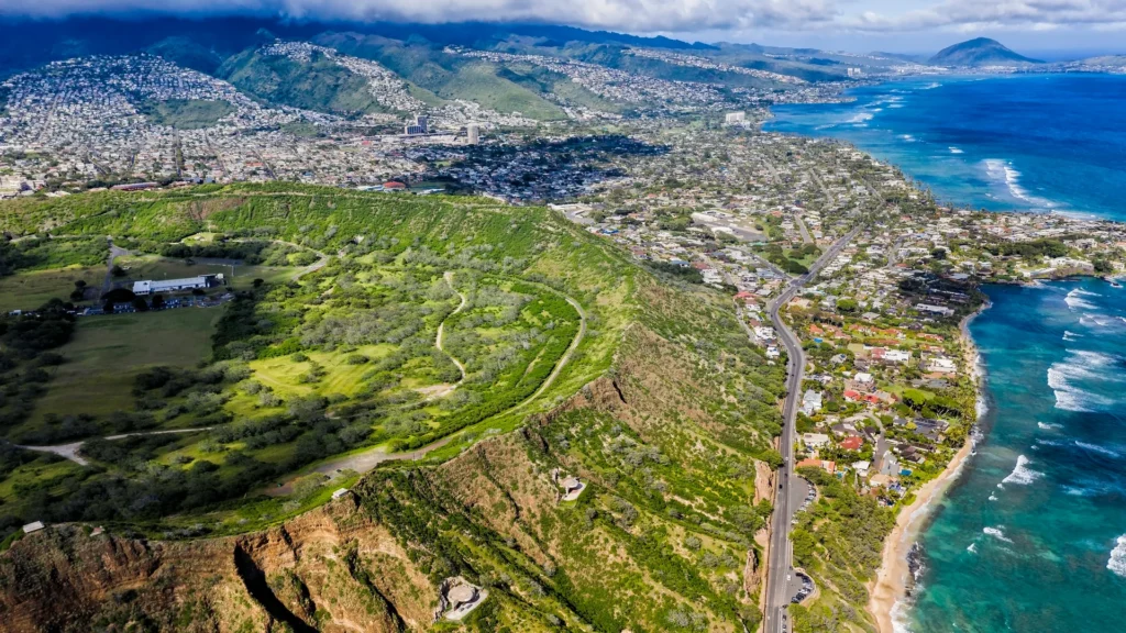 An aerial view of Diamond Head, nearby roads, and the Oahu coastline.
