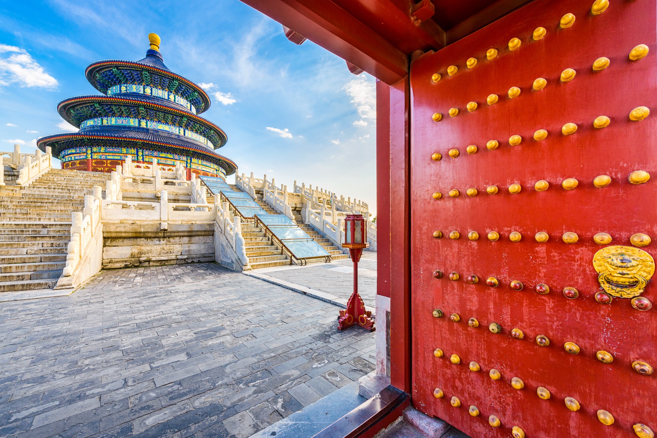The blue-roofed Hall of Prayer for Good Harvests seen through a red gateway at Beijing’s Temple of Heaven