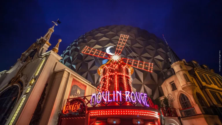 The illuminated Moulin Rouge facade and Eurosat sphere in Europa-Park’s French themed area.