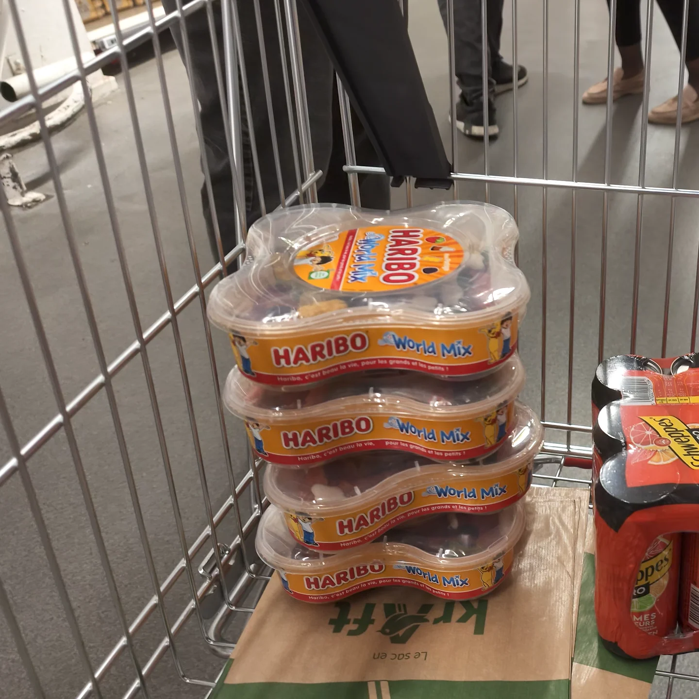 Four Haribo World Mix tubs stacked in a supermarket cart at La Défense.