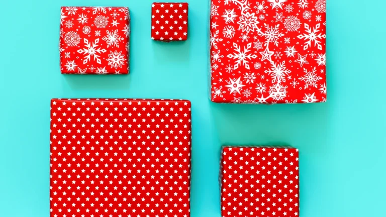 Red and white patterned gift boxes arranged on a turquoise background.