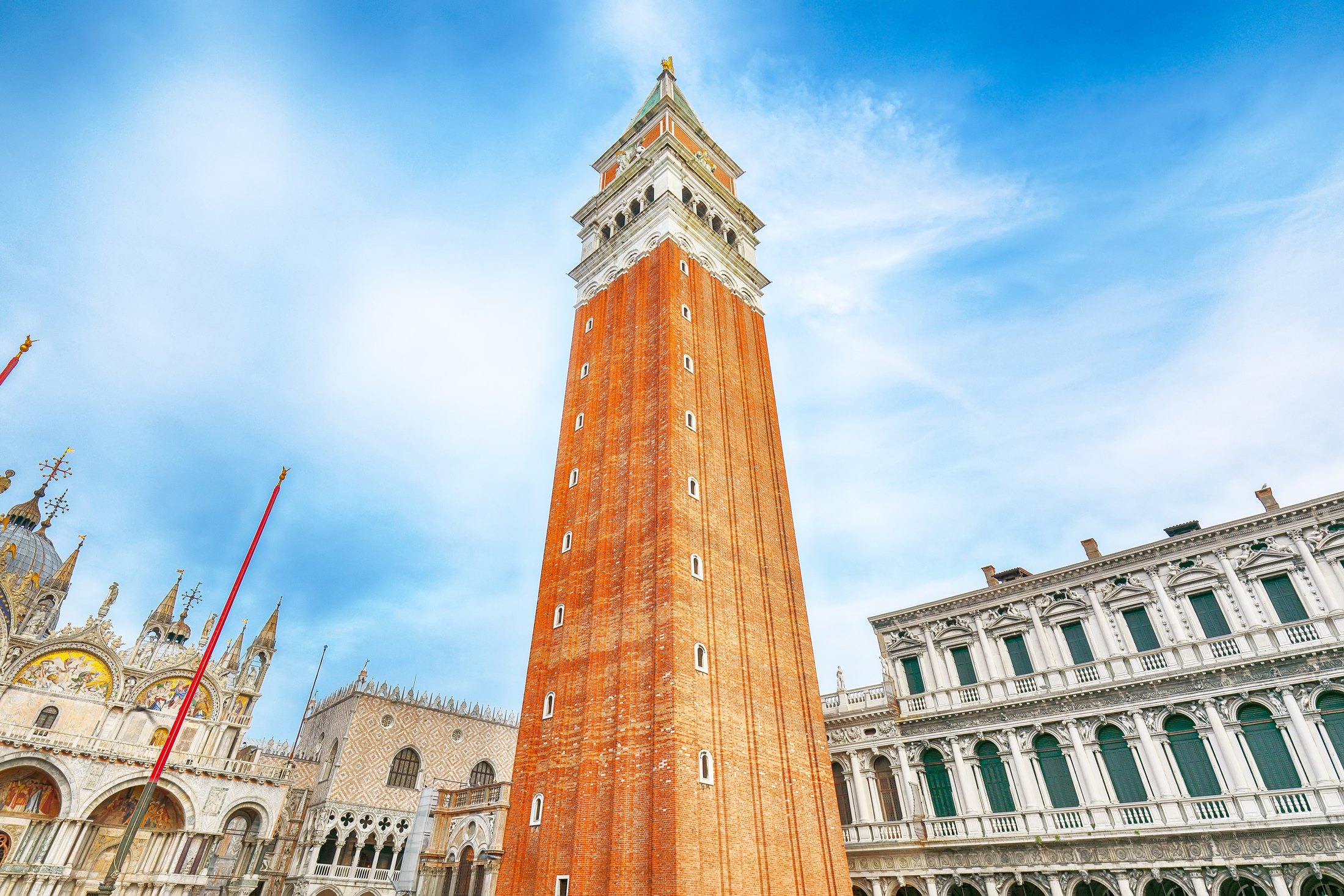 St. Mark’s brick bell tower rises above Piazza San Marco beside the basilica in Venice