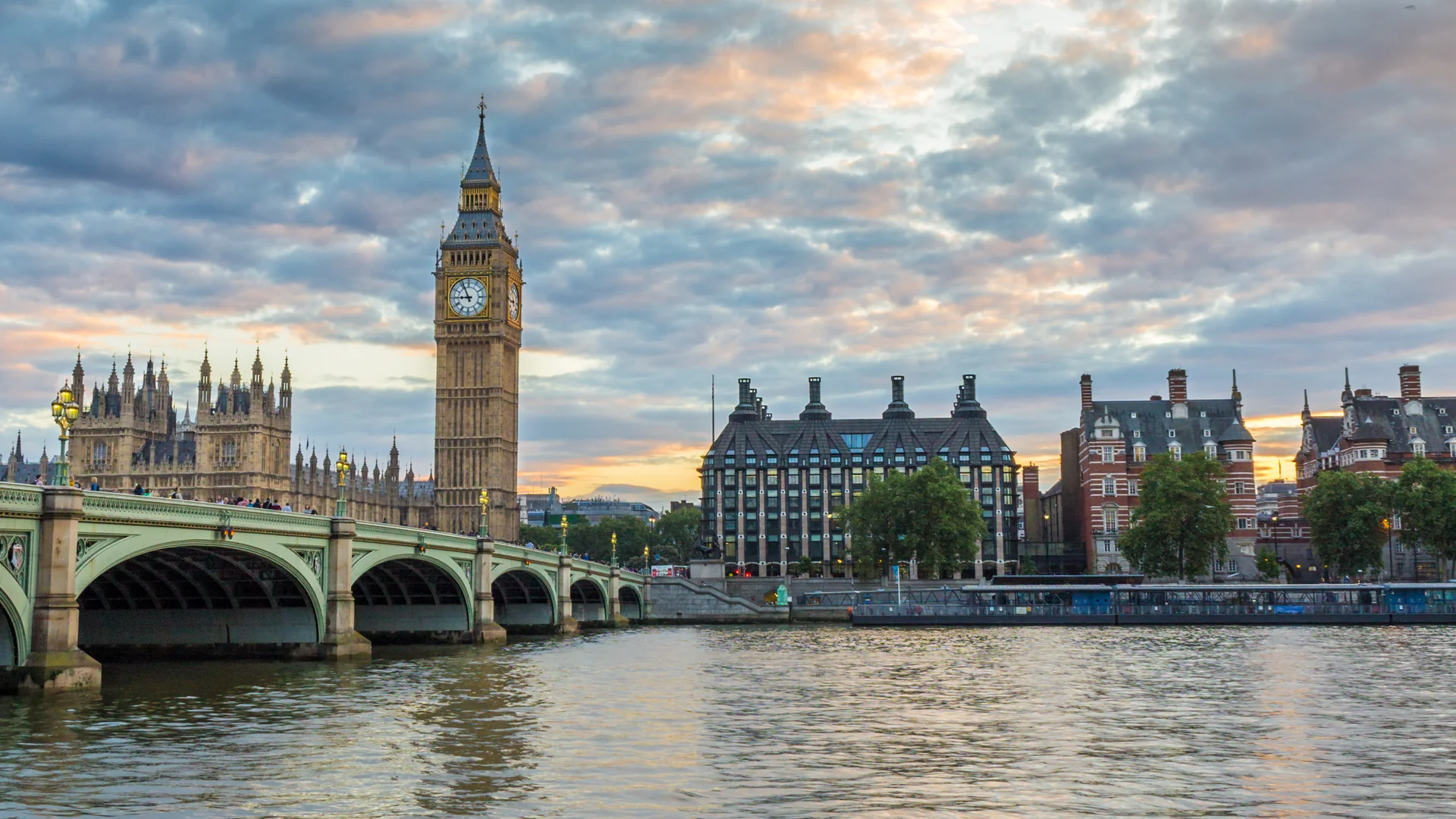 Westminster Bridge, Elizabeth Tower, and the River Thames beneath a colorful sky