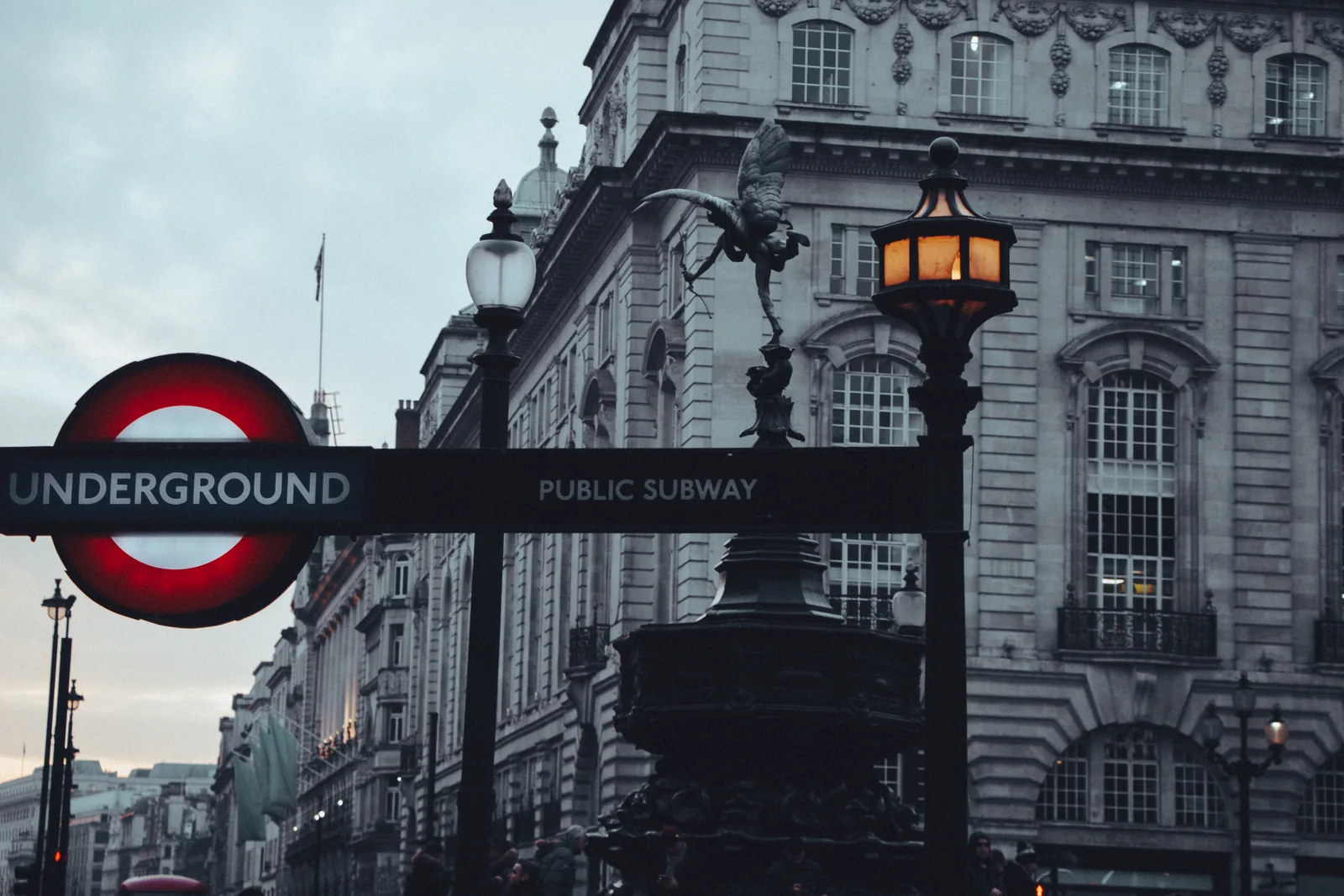 A London Underground roundel photographed in low evening light.
