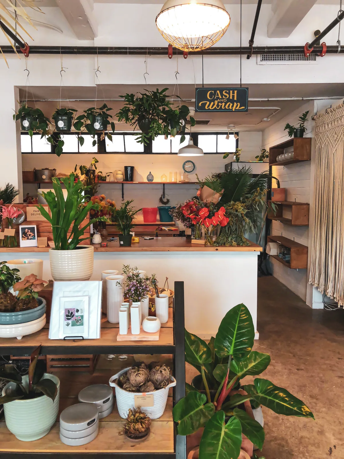 Plants, flowers, cards, and gifts displayed inside a small flower shop on Oahu.