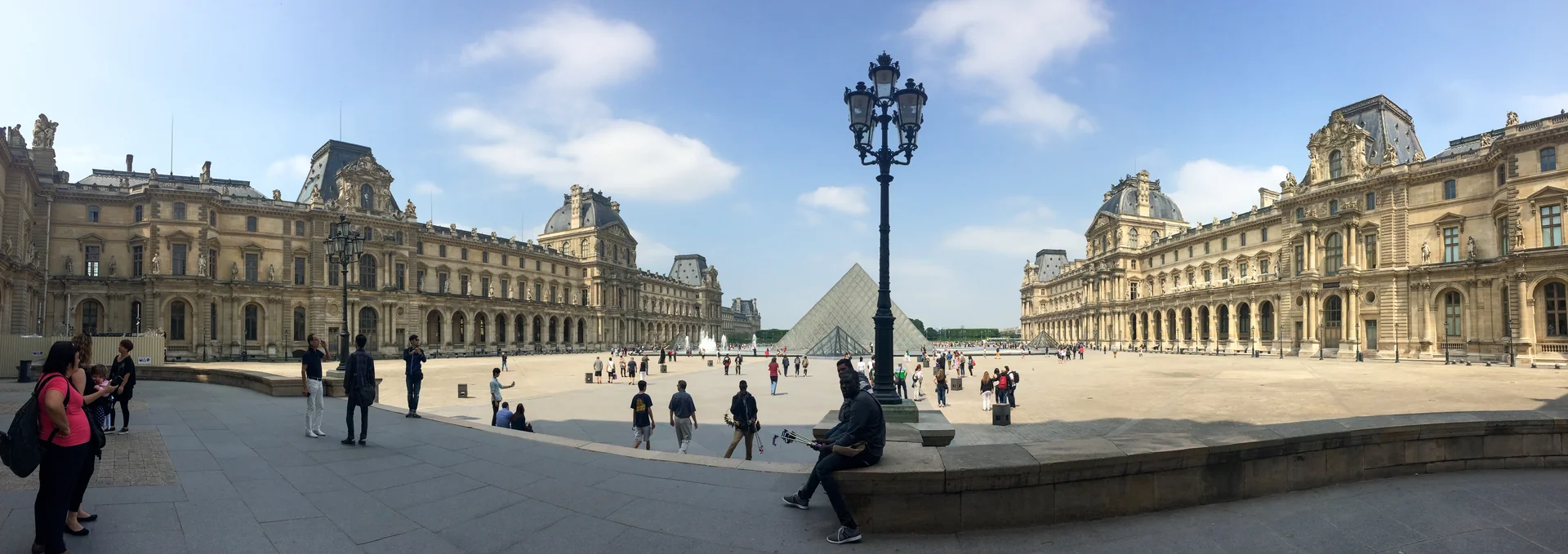 The Louvre’s palace buildings frame the courtyard and glass Pyramid