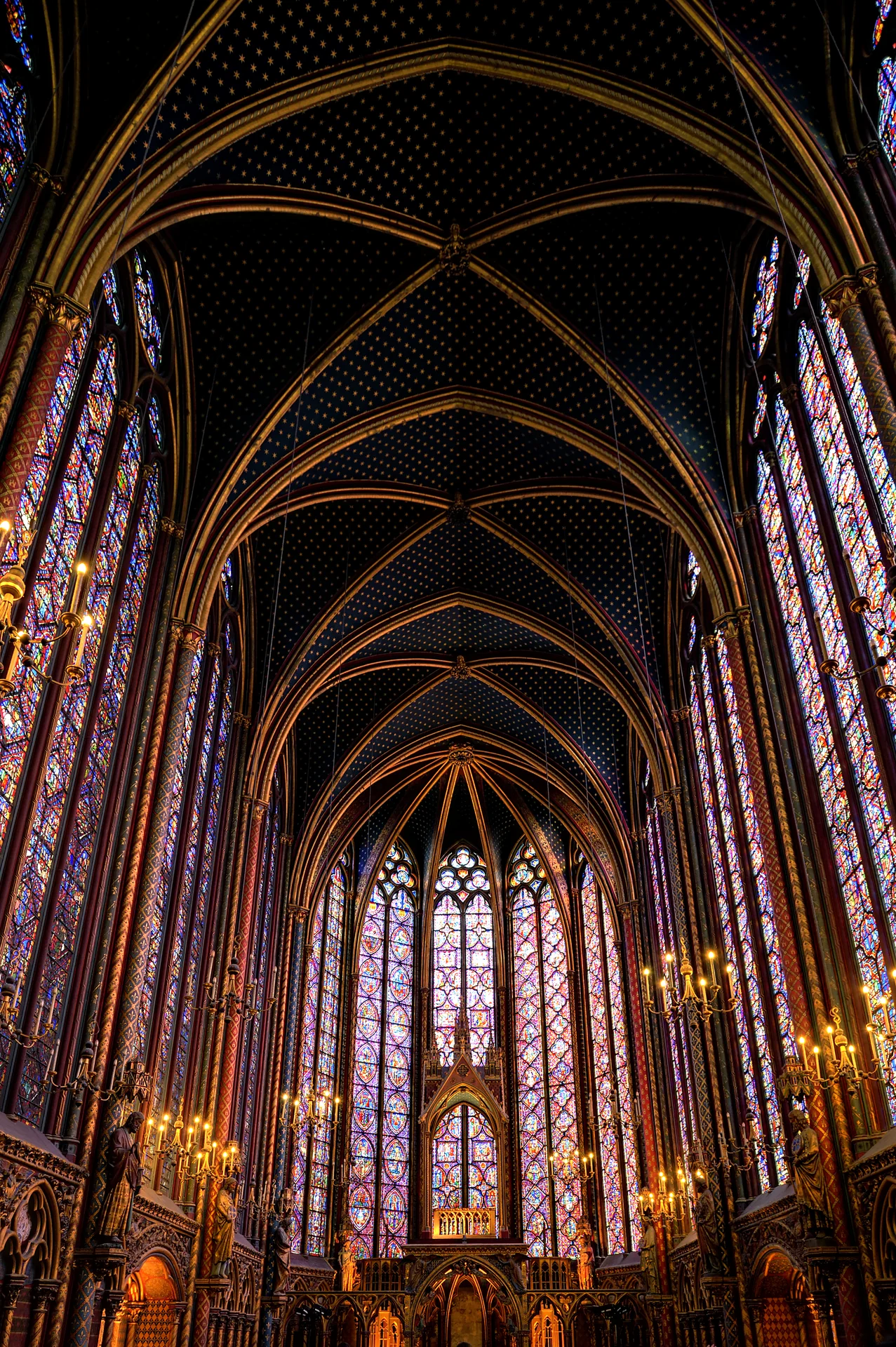 Tall stained-glass windows and a ribbed ceiling enclose Sainte-Chapelle’s upper chapel