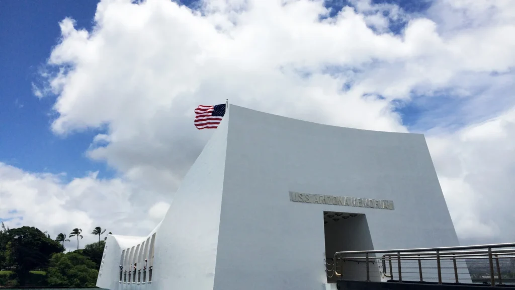 The white USS Arizona Memorial building and its entrance walkway at Pearl Harbor.